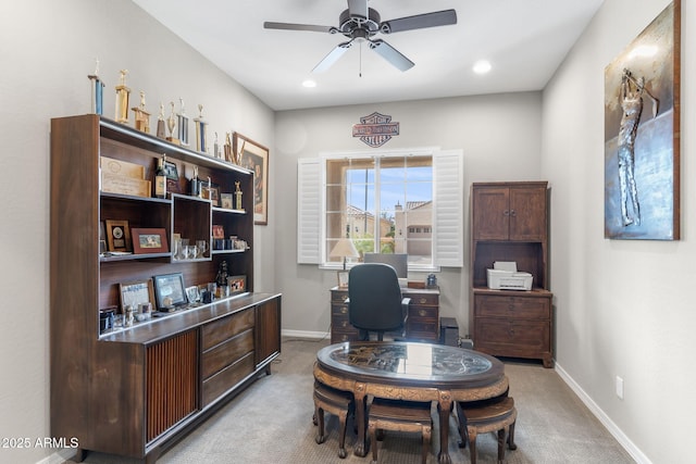 office area featuring light carpet and ceiling fan