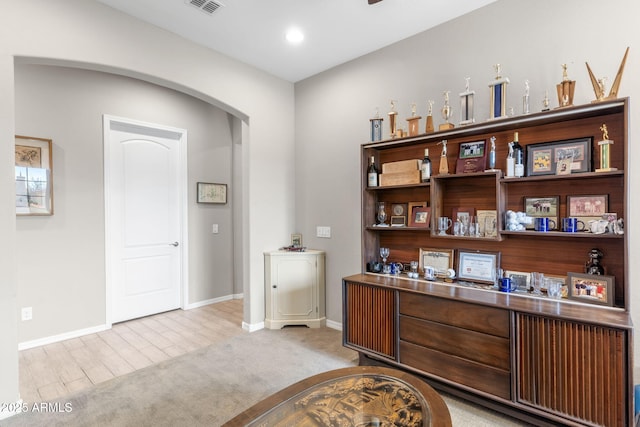 bar with light colored carpet and stainless steel counters