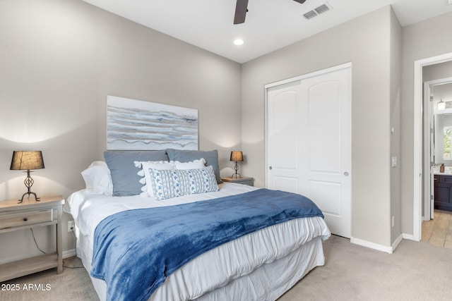 bedroom featuring light carpet, a closet, and ceiling fan