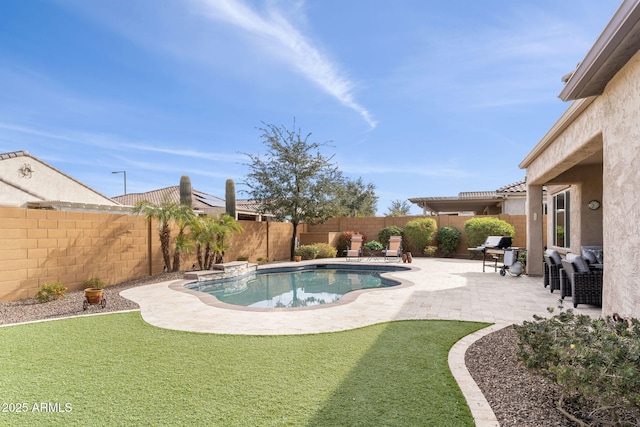 view of swimming pool with grilling area and a patio area