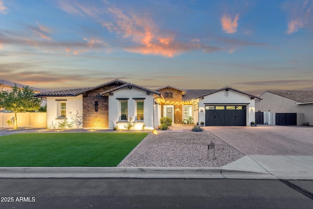 view of front facade with driveway, a front yard, fence, an attached garage, and stucco siding