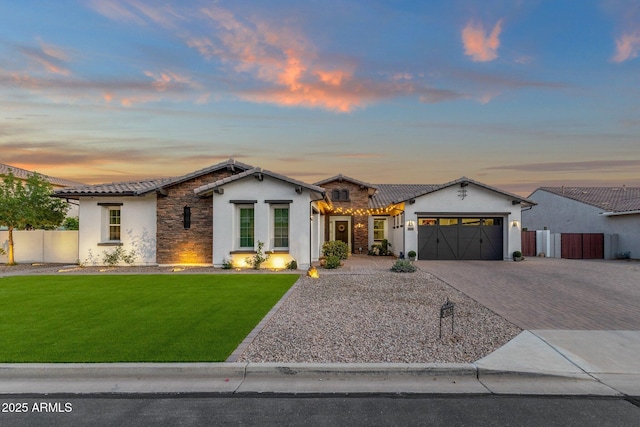 view of front of home featuring stucco siding, a tiled roof, and stone siding