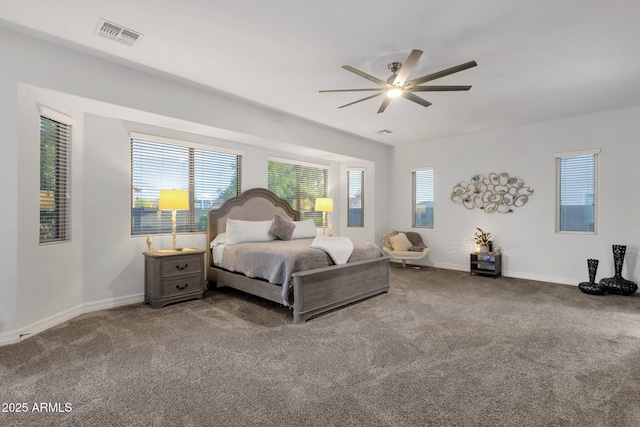 bedroom featuring baseboards, multiple windows, and carpet