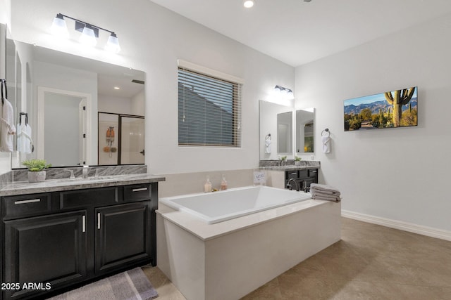 bathroom with a sink, recessed lighting, two vanities, a bath, and a stall shower