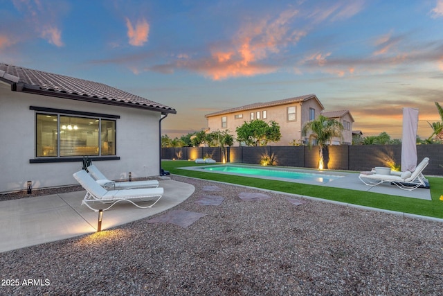 view of yard featuring a patio, a fenced backyard, and a fenced in pool
