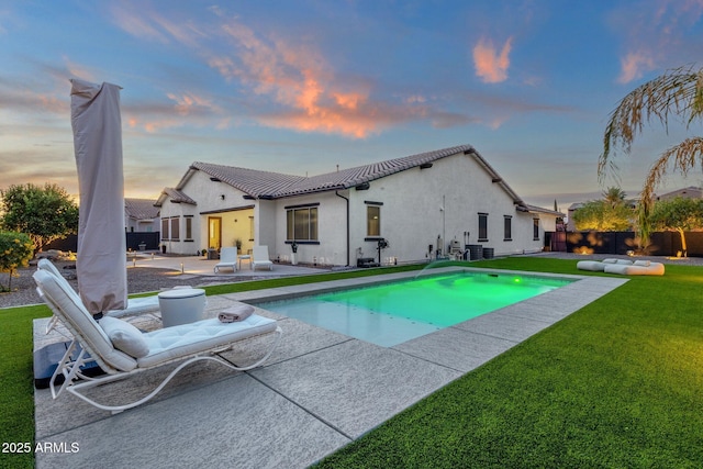 view of pool with a fenced backyard, a fenced in pool, central AC unit, a patio area, and a yard