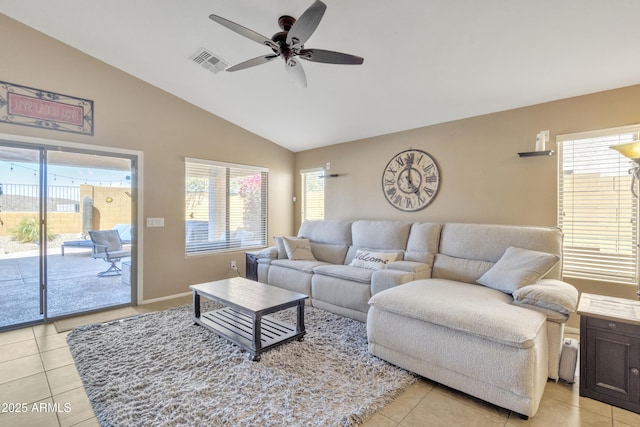 living room featuring ceiling fan, light tile patterned floors, and lofted ceiling