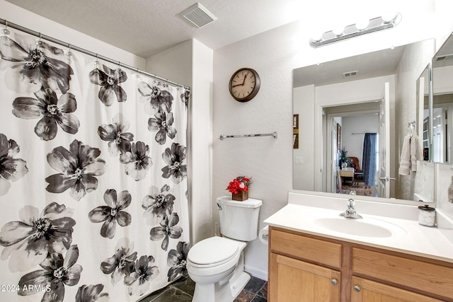 bathroom featuring toilet, a textured ceiling, vanity, and visible vents