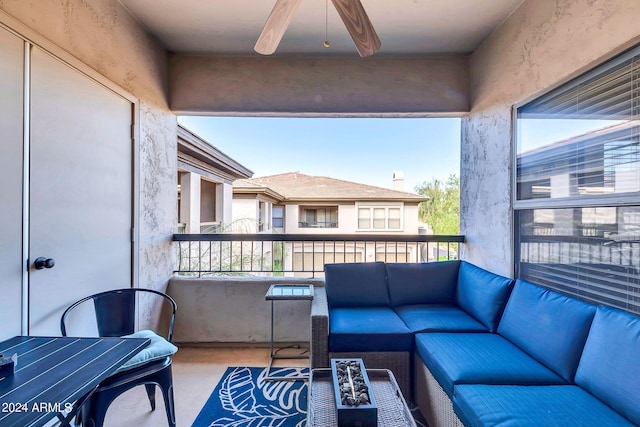 balcony with a ceiling fan and an outdoor living space