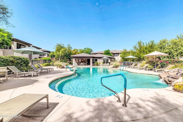 community pool featuring a patio and fence