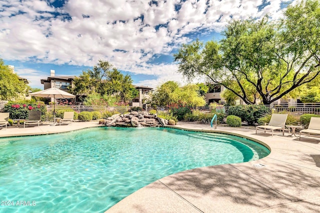 community pool featuring fence and a patio