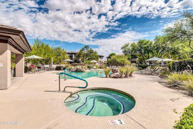 pool with a community hot tub and a patio area