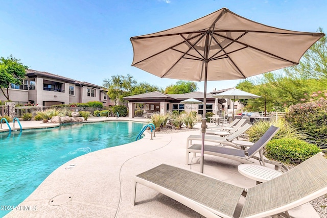 community pool featuring a patio area and fence