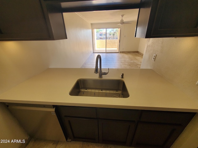 kitchen featuring stainless steel dishwasher, sink, light tile patterned flooring, and ceiling fan