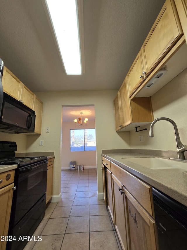 kitchen featuring light brown cabinetry, sink, black appliances, light tile patterned floors, and pendant lighting