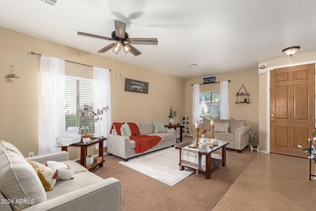 tiled living room with ceiling fan