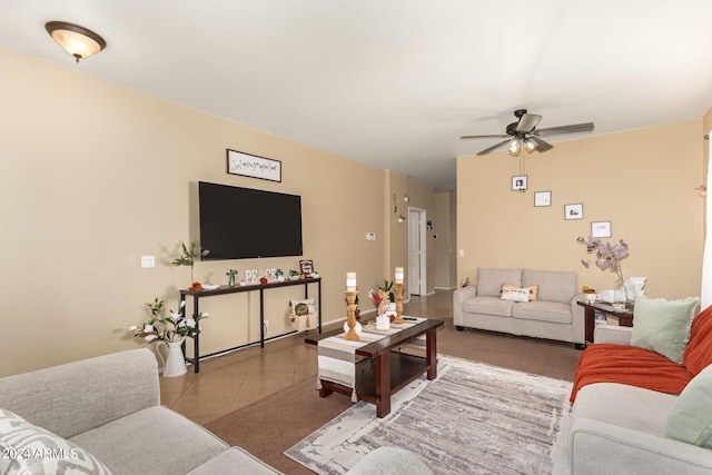 living room with ceiling fan and tile patterned flooring