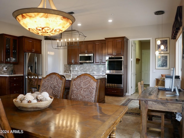 dining area featuring light tile patterned floors and a notable chandelier