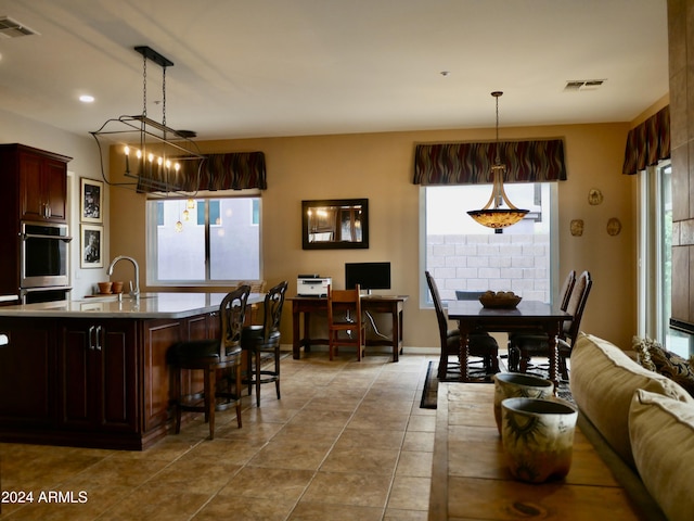 kitchen with pendant lighting, plenty of natural light, and sink