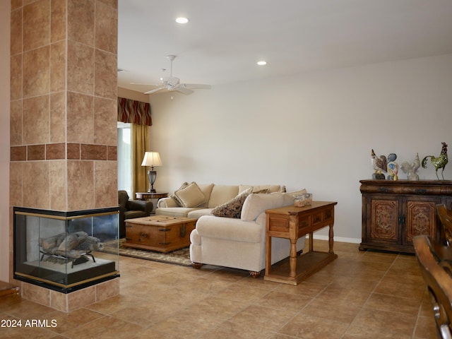 tiled living room featuring a tiled fireplace, ceiling fan, and tile walls