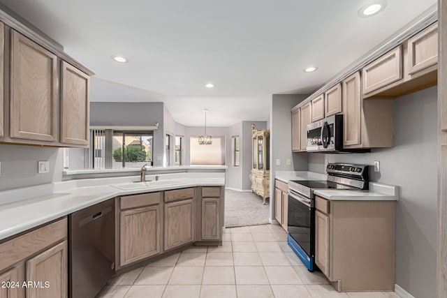 kitchen featuring pendant lighting, sink, light tile patterned floors, appliances with stainless steel finishes, and a notable chandelier