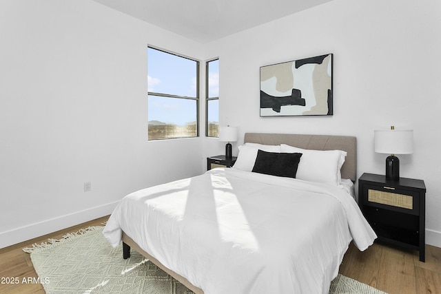 bedroom with wood-type flooring