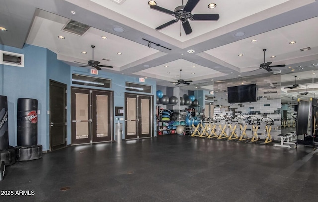 workout area featuring french doors and coffered ceiling