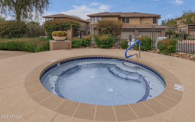 view of swimming pool with a hot tub