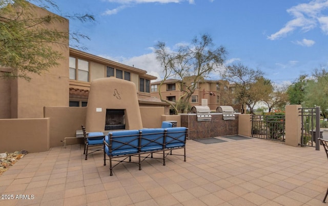 view of patio featuring an outdoor living space with a fireplace and a grill