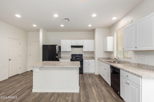 kitchen with white cabinetry, a kitchen island, and black appliances