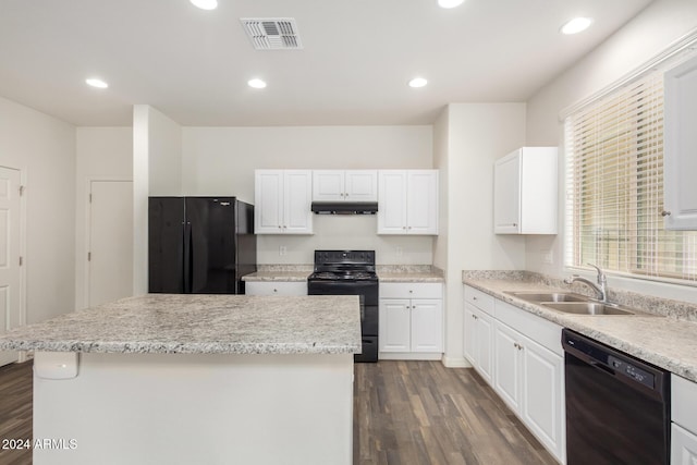 kitchen with white cabinets, sink, a kitchen island, and black appliances