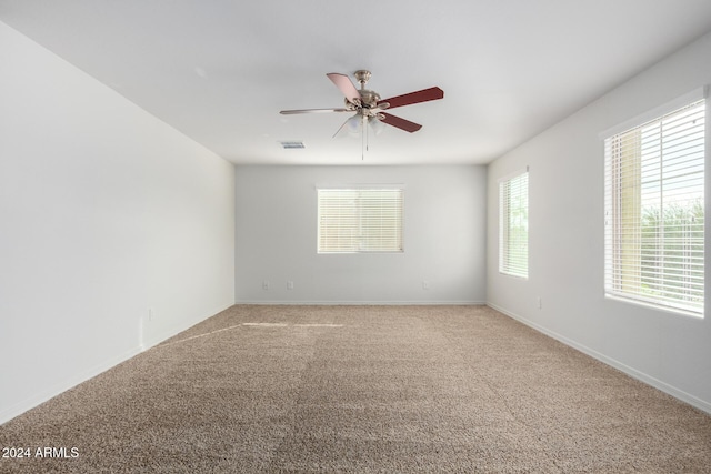 unfurnished room with carpet flooring and ceiling fan