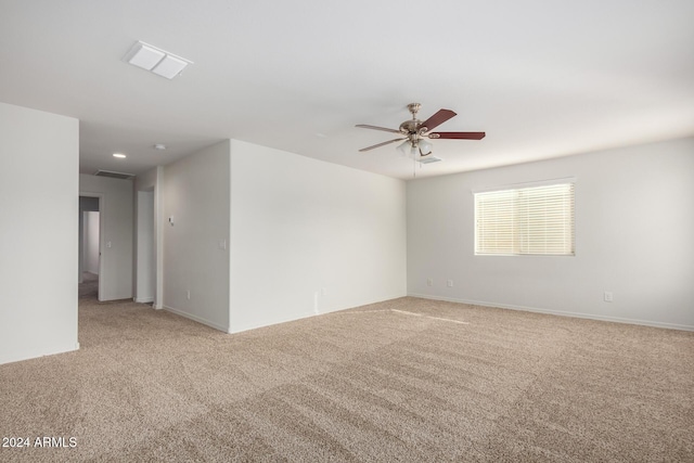 unfurnished room featuring light carpet and ceiling fan