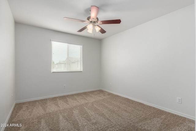 spare room featuring carpet and ceiling fan