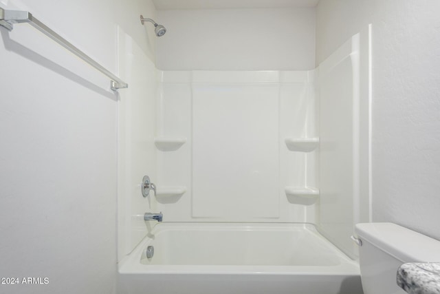 bathroom with shower / washtub combination and toilet