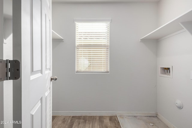 laundry room with light hardwood / wood-style floors and hookup for a washing machine