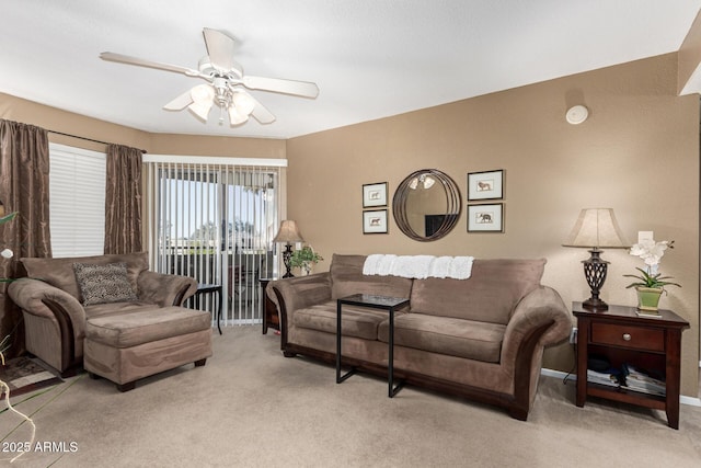 living room featuring ceiling fan and light colored carpet