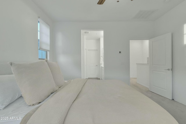 carpeted bedroom featuring ensuite bath and ceiling fan