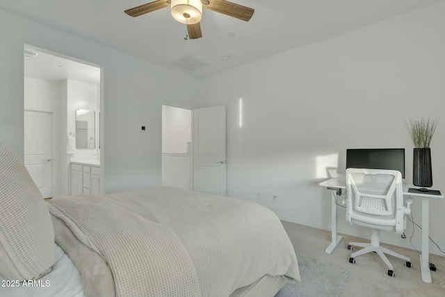 carpeted bedroom featuring ceiling fan and ensuite bathroom