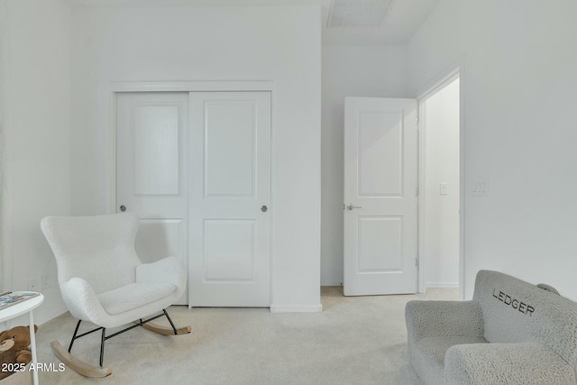 living area featuring light colored carpet