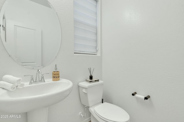 bathroom featuring sink and toilet