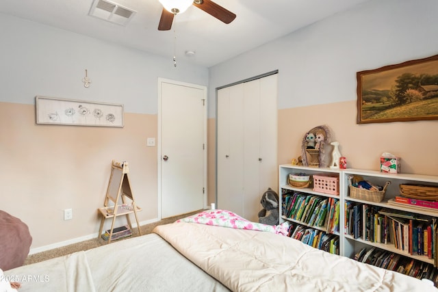 carpeted bedroom with a closet and ceiling fan