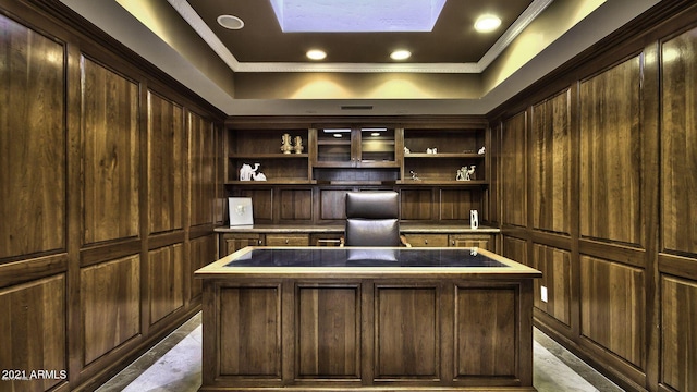 unfurnished office featuring crown molding, a tray ceiling, and wood walls