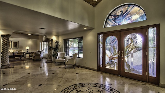 entrance foyer with ornate columns and french doors