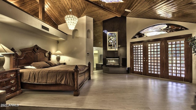 bedroom with high vaulted ceiling, beamed ceiling, french doors, hardwood / wood-style flooring, and wooden ceiling