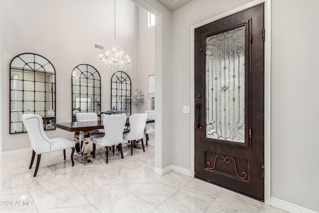 foyer entrance with a chandelier