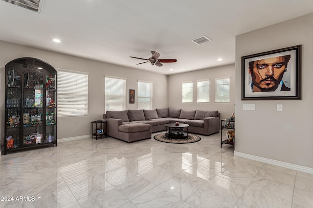 living room featuring ceiling fan and a healthy amount of sunlight