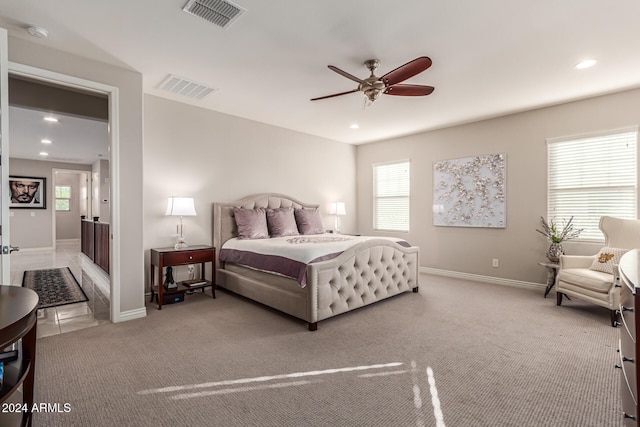 bedroom with carpet floors, multiple windows, and ceiling fan