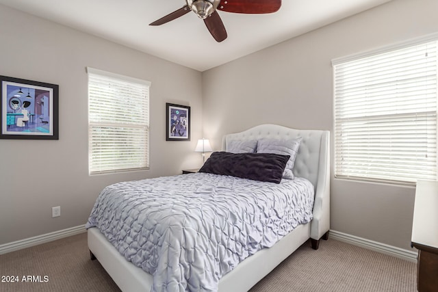 bedroom featuring carpet floors, multiple windows, and ceiling fan