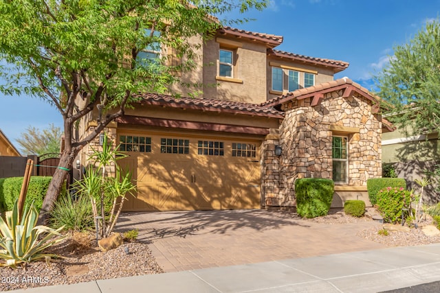 mediterranean / spanish-style home with a garage